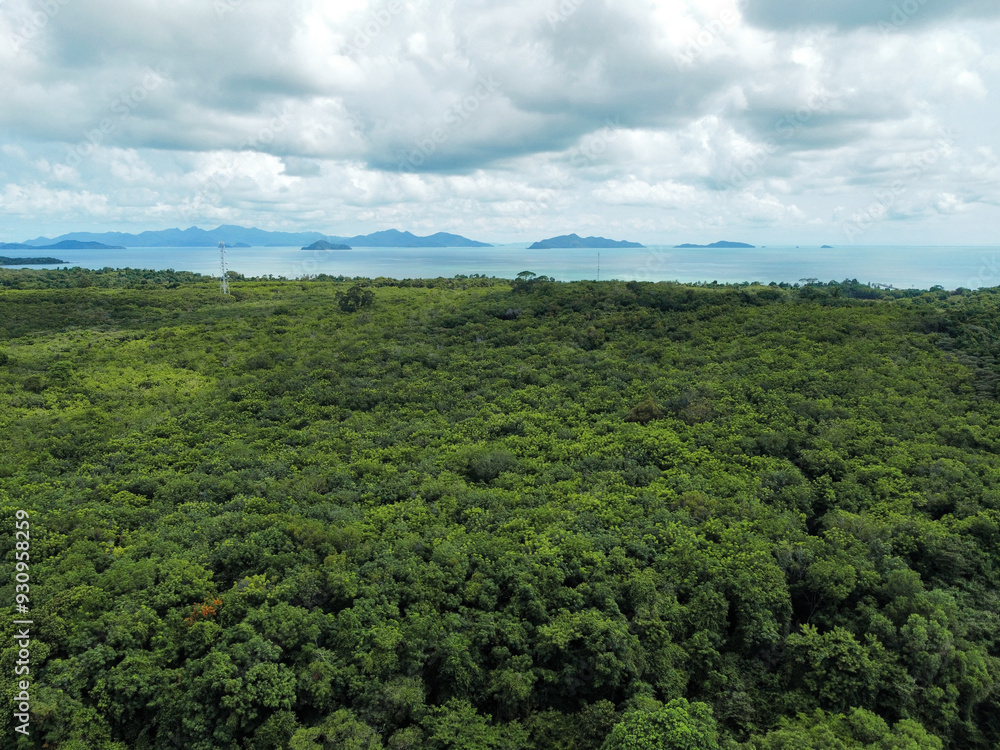 Fototapeta premium Aerial view of Koh Mak with a tropical forest and the sea and Koh Chang in the horizon, Thailand
