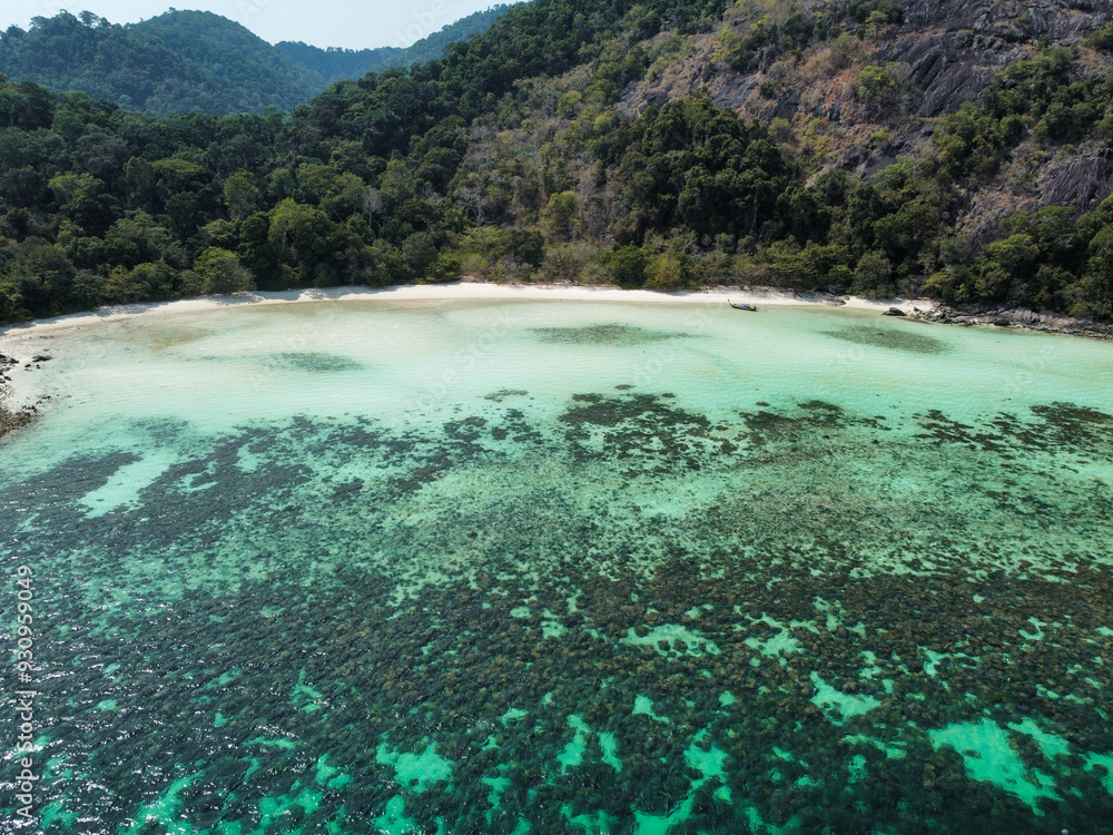 Aerial view of Ko Ra Wi at low tide with coral reef, turquoise water and white sand beach; this remote island is part of the Tarutao national park and marine reserve, Satun, Thailand Aerial view of Ko Ra Wi at low tide with coral reef, turquoise water and white sand beach; this remote island is part of the Tarutao national park and marine reserve, Satun, Thailand