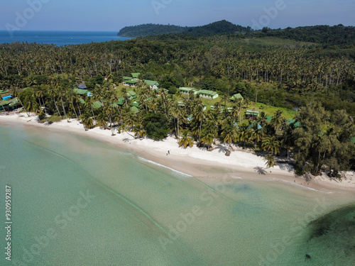 Aerial view of a remote beach in a tropical island with white sand beach, palm trees and transparent calm water, Koh Kood, Trat, Thailand photo