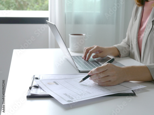 Young businesswoman holds a resume and evaluates it. Views the personal history of job applicants. Recruitment concept