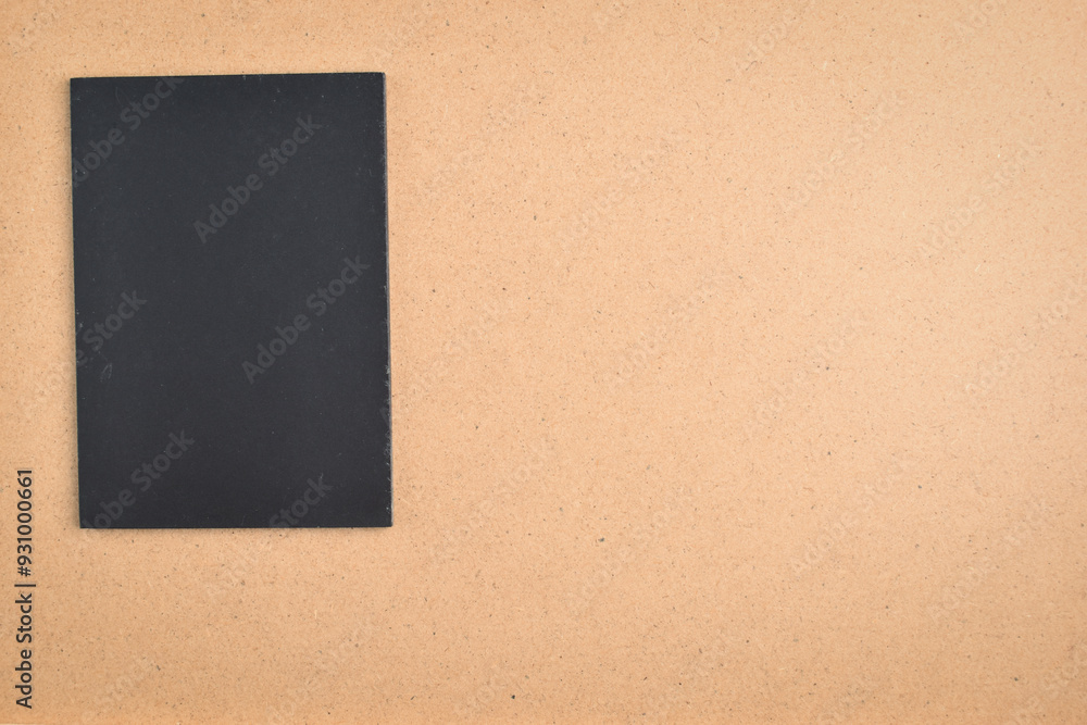 Fototapeta premium blank black notebook on brown wood texture background