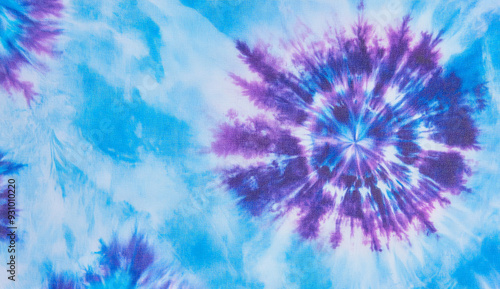 Abstract tie dye fabric background in blue and purple shades.