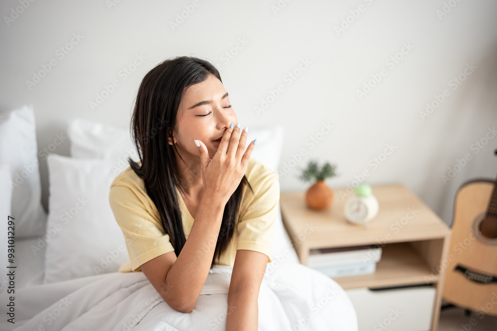 Asian young beautiful woman getting up from sleep on bed in the morning. Asian young beautiful woman getting up from sleep on bed in the morning.