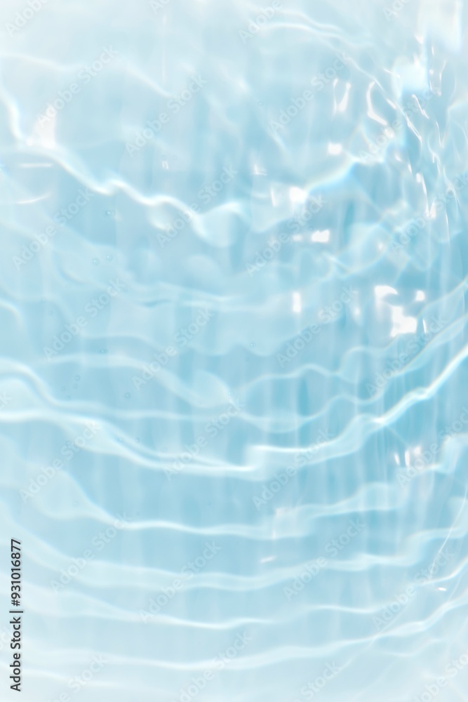 Obraz premium Blue water with ripples on the surface. Defocus blurred transparent blue colored clear calm water surface texture with splashes and bubbles. Water waves with shining pattern texture background. 