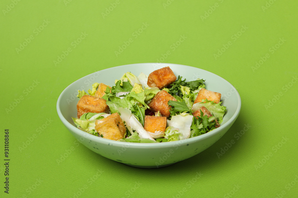 Fried tofu salad on a green background Fried tofu salad on a green background