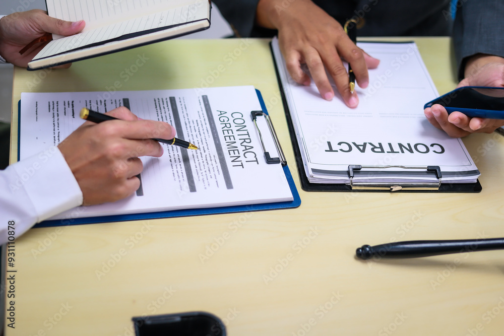 A lawyer is seated at a desk in an office, reviewing and signing legal documents. The scene captures a professional setting focused on contracts, finance, providing legal advice to clients. A lawyer is seated at a desk in an office, reviewing and signing legal documents. The scene captures a professional setting focused on contracts, finance, providing legal advice to clients.