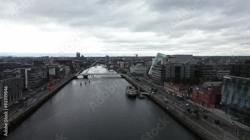 Wallpaper Mural Dolly drone shot over Dublin city by the river Liffey moving backwards with Liberty Hall Samuel Beckett Bridge and IFSC International Financial Services Centre. Torontodigital.ca