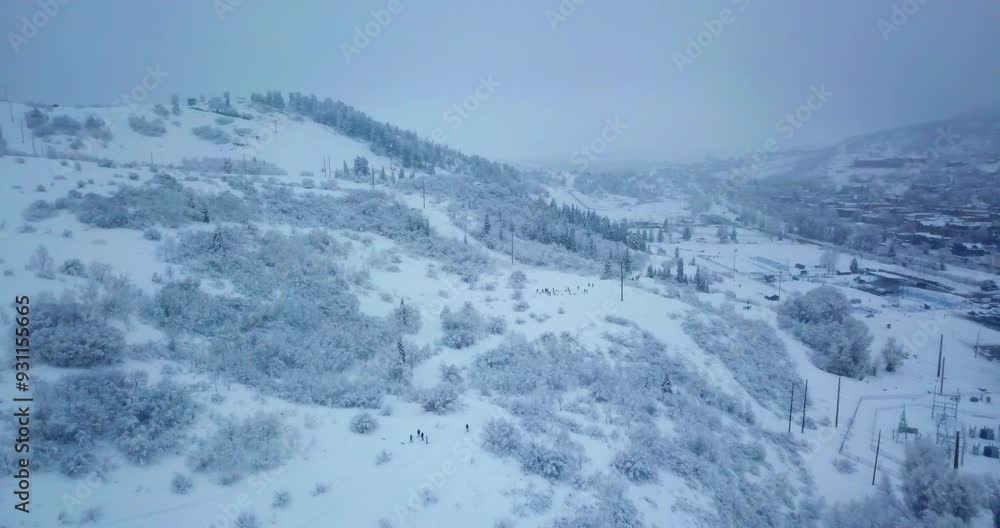 Aerial Panning Scenic Shot Of People For Skiing On Hills During Snowfall - Park City, Utah Aerial Panning Scenic Shot Of People For Skiing On Hills During Snowfall - Park City, Utah