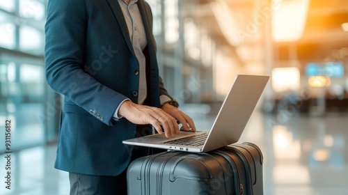 Businessman working on laptop while waiting at airport.