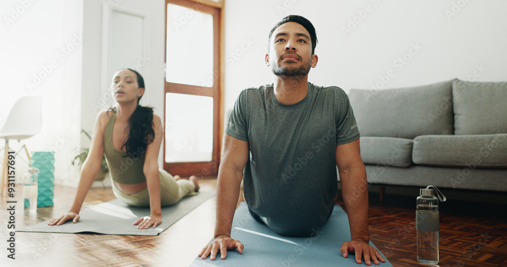 © PeakPoints/peopleimages.com - Yoga, couple and stretching in home for calm, wellness and spiritual healing. Man, woman and cobra pose in pilates for healthy body, activity in relationship and positive mental health in living room