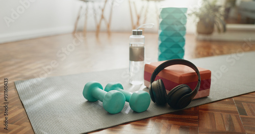 Fotografie Headphones, mat and dumbbells with water bottle of fitness equipment or interior on floor at home