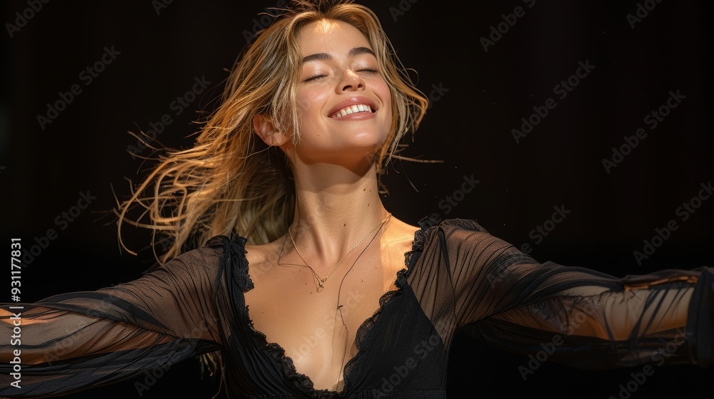 Naklejka premium A young woman joyfully performing on stage during a vibrant evening performance in a theater