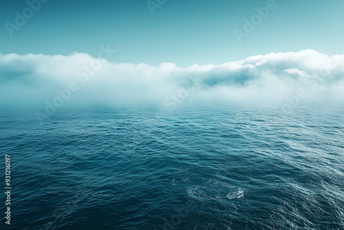 mystical ocean horizon with low-lying clouds and deep blue water creating an atmospheric and serene seascape