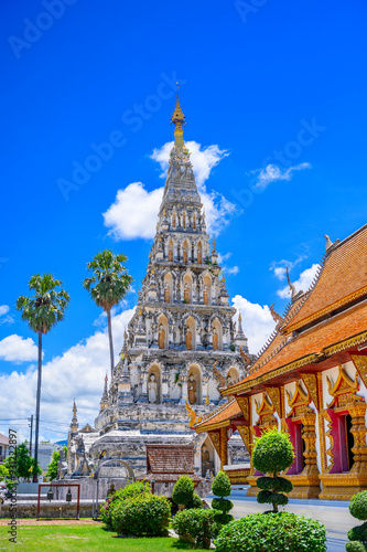 Wat Chedi Liem, also known as Wat Kum Kam, is a majestic ancient temple in Chiang Mai, Thailand. The white stupa with golden accents stands tall against a bright blue sky