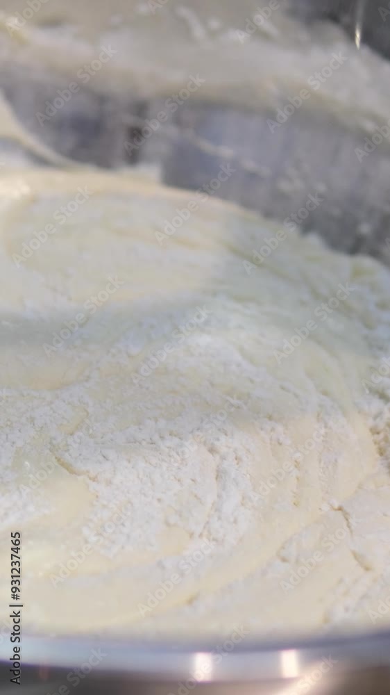 Adding flour to cookie batter and stirring with wooden spoon. stir flour into batter Adding flour to cookie batter and stirring with wooden spoon. stir flour into batter