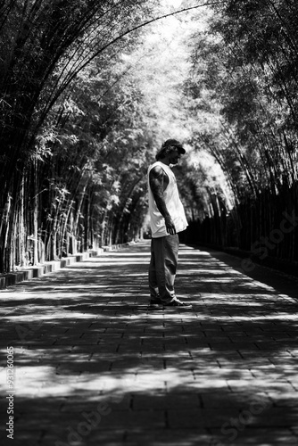 Tattooed man in a bamboo tunnel. photo