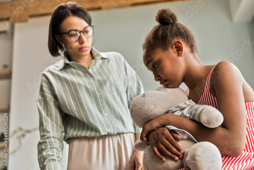 African American woman scolding daughter, girl offended and hurt photo