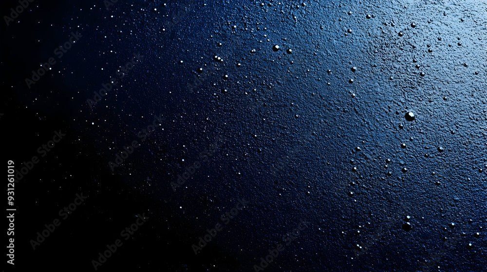 Close-up of water droplets on a dark textured surface. Close-up of water droplets on a dark textured surface.