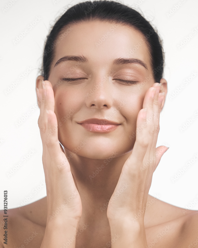 Serene Woman with Radiant Skin Gently Touching Her Face Serene Woman with Radiant Skin Gently Touching Her Face