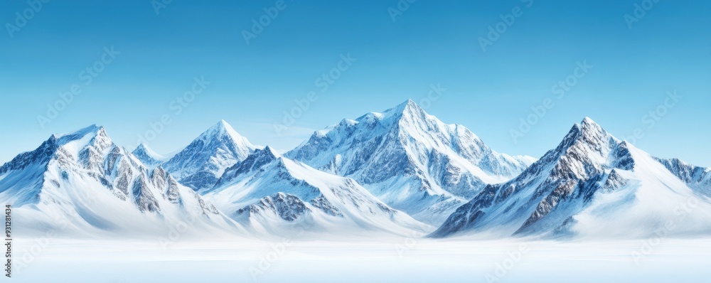 Fototapeta premium Snow-covered mountains beneath a clear blue sky, creating a peaceful winter scene