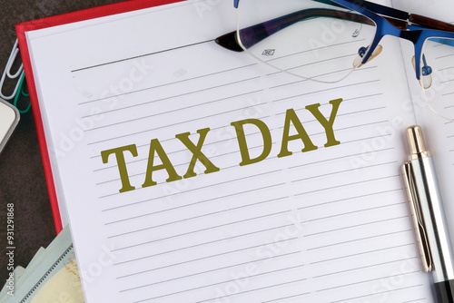 Tax Day Taxation Financial Money Money Concept. Words TAX DAY in the notebook of a businessman, a top manager, a manager