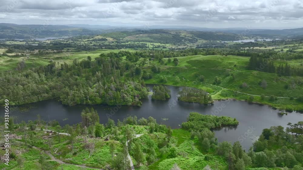 Secluded lake with slow pan showing lush green countryside. Tarn Hows, Lake District National Park, Cumbria, UK Secluded lake with slow pan showing lush green countryside. Tarn Hows, Lake District National Park, Cumbria, UK