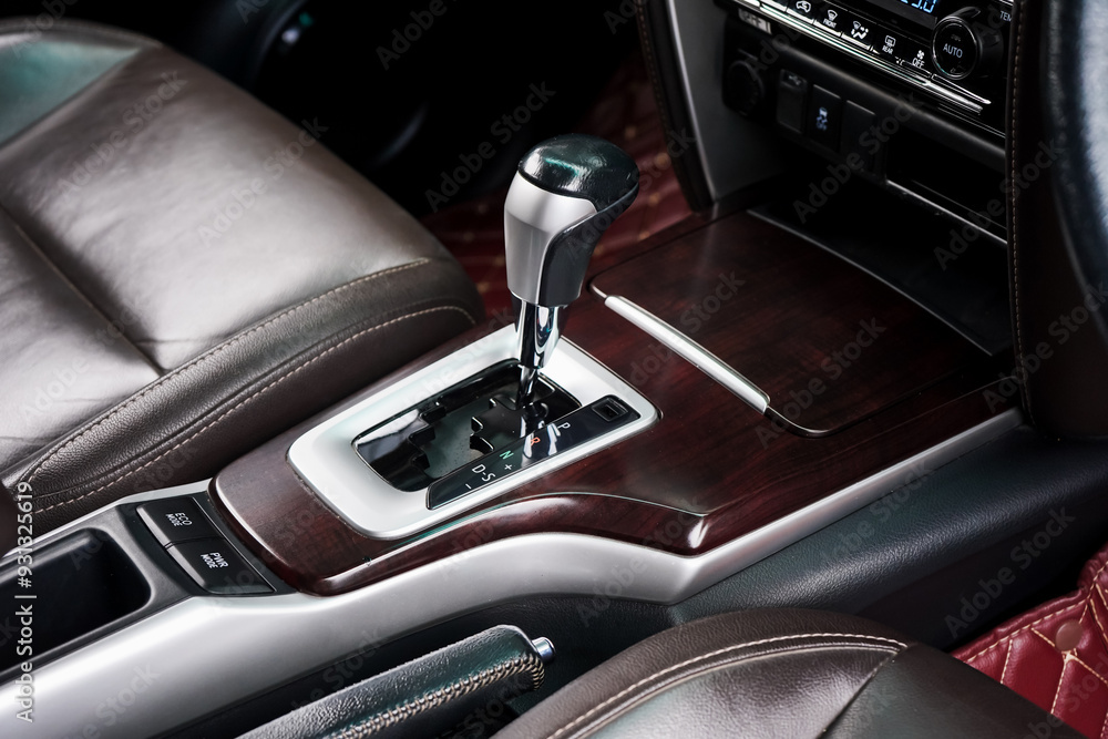 automatic transmission shift selector in the car interior. Closeup a manual shift of modern car gear shifter. 4x4 gear shift automatic transmission shift selector in the car interior. Closeup a manual shift of modern car gear shifter. 4x4 gear shift
