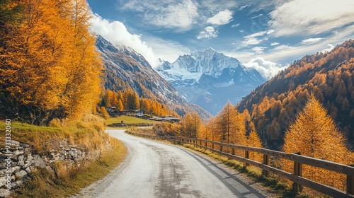 The road to the skiing village of Courmayeur in the Italian Alps during autumn on a sunny day, with vibrant fall foliage and a stunning view of Mont Blanc in the background.