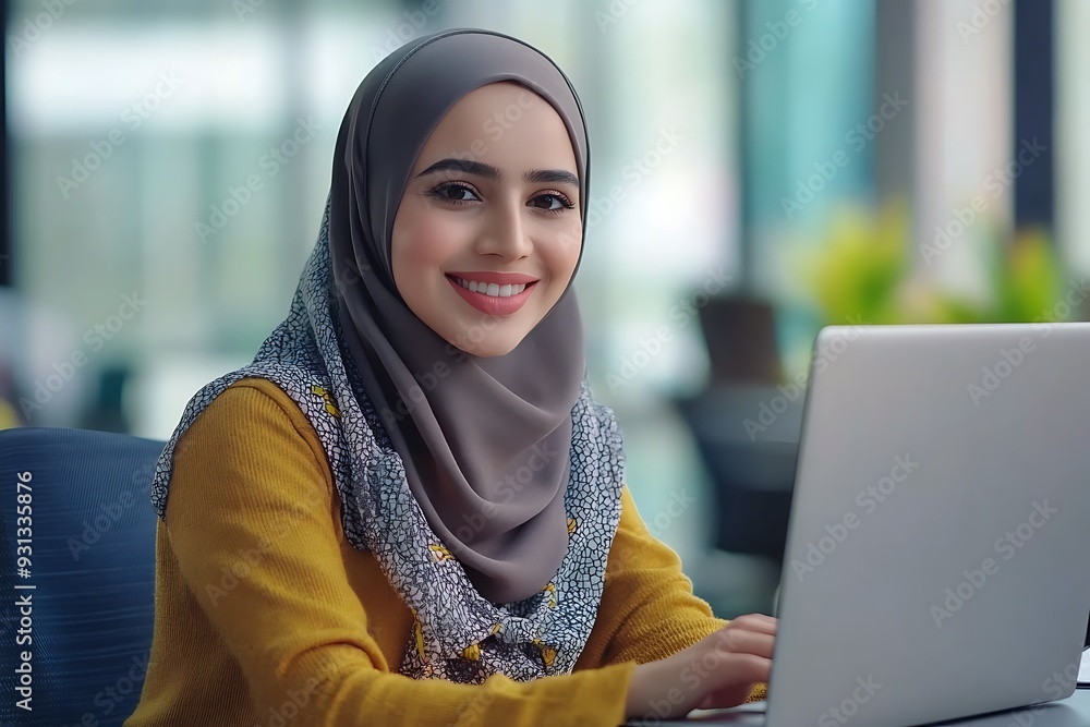 Smiling Arab Woman in Hijab Working at Office Desk Smiling Arab Woman in Hijab Working at Office Desk