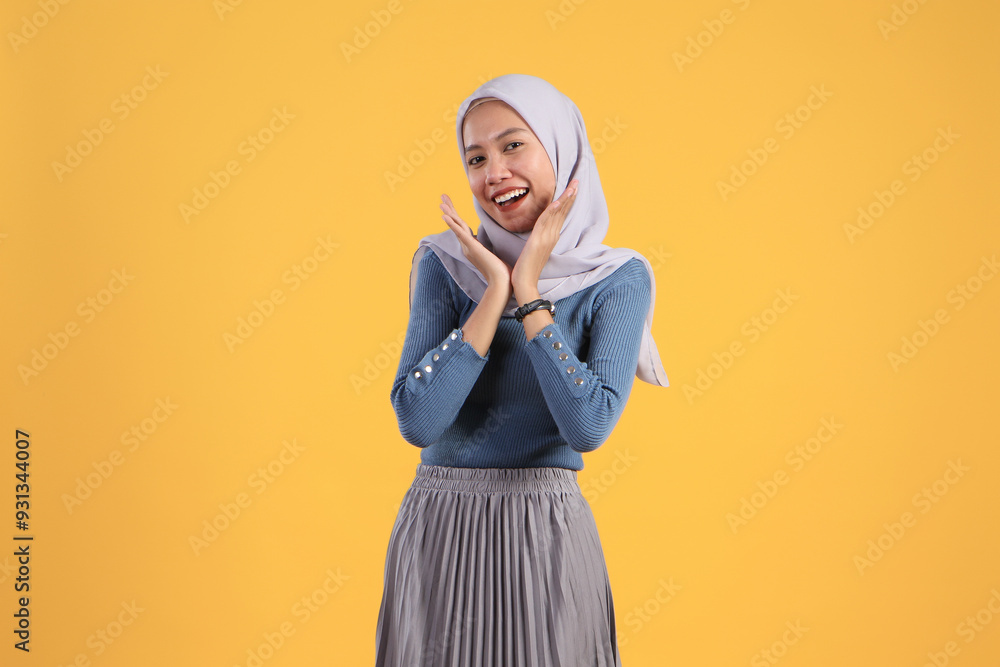 happy asian indonesian muslim woman with cheerful expression on isolated yellow background happy asian indonesian muslim woman with cheerful expression on isolated yellow background