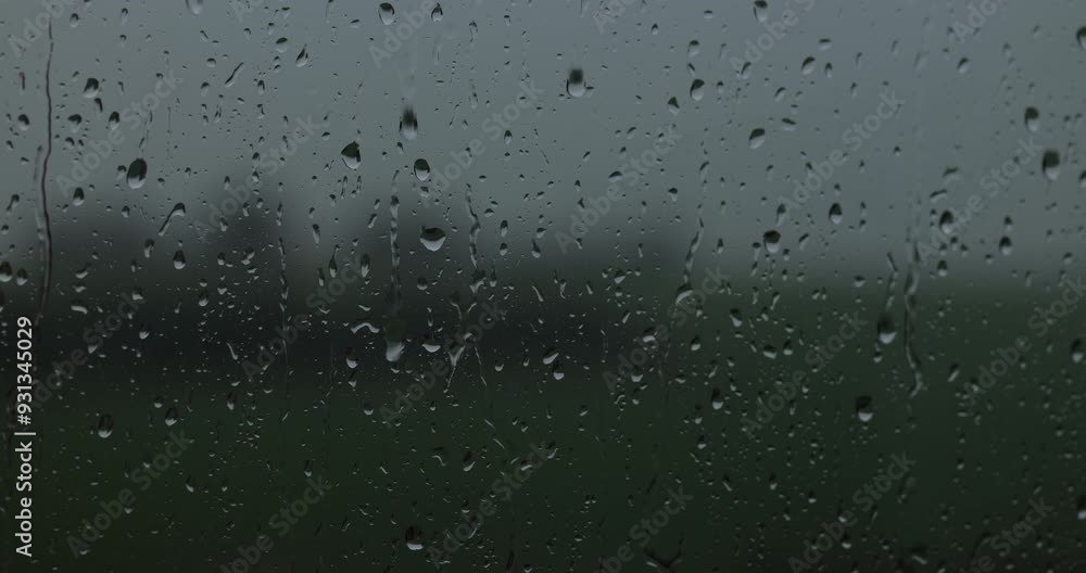 drop of rain on a window. close-up of a window with water drops. drop of rain trickles down the window pane. a window in rainy weather drop of rain on a window. close-up of a window with water drops. drop of rain trickles down the window pane. a window in rainy weather