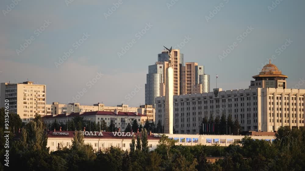 Monument ascending over city buildings at sunset with a clear sky. Russia, Samara Monument ascending over city buildings at sunset with a clear sky. Russia, Samara