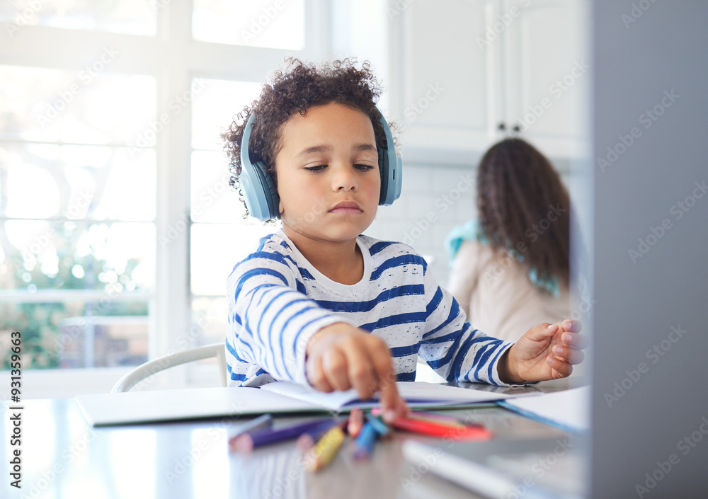 Child, headphones and e learning with laptop at house for education, writing assessment and studying. Boy, stationery and online class for creative drawing, colourful sketch and childhood development