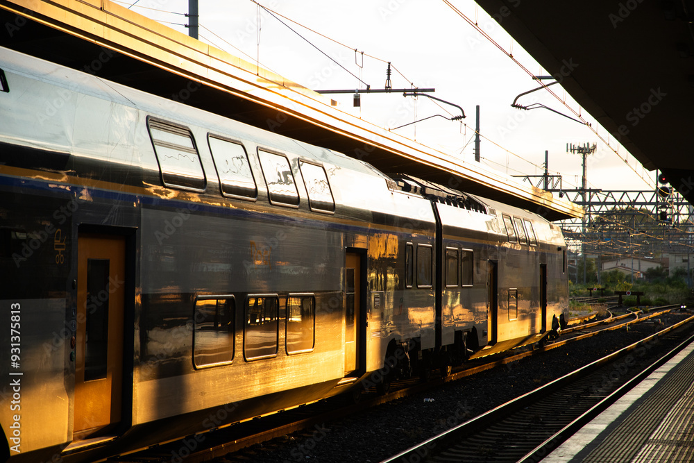 Fototapeta premium trains in train station in golden sunset light