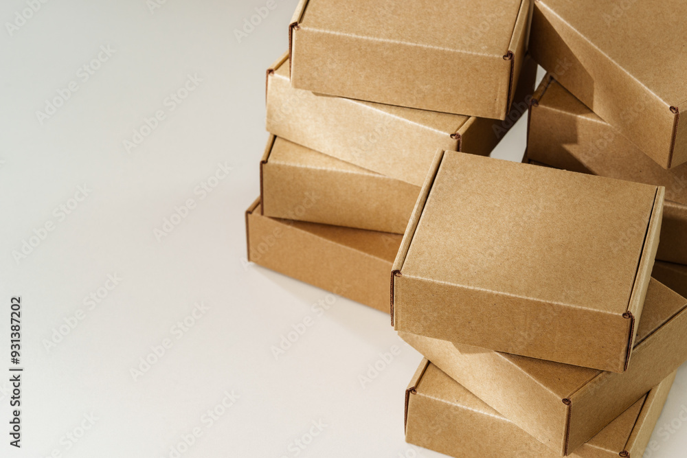 Stacked Brown Cardboard Boxes on White Surface Stacked Brown Cardboard Boxes on White Surface