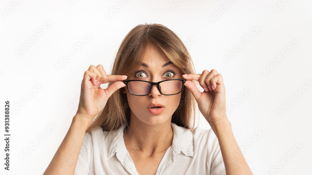 Omg. Amazed Woman Looking At Camera Over Eyeglasses Standing On White Studio Background. Isolated Omg. Amazed Woman Looking At Camera Over Eyeglasses Standing On White Studio Background. Isolated