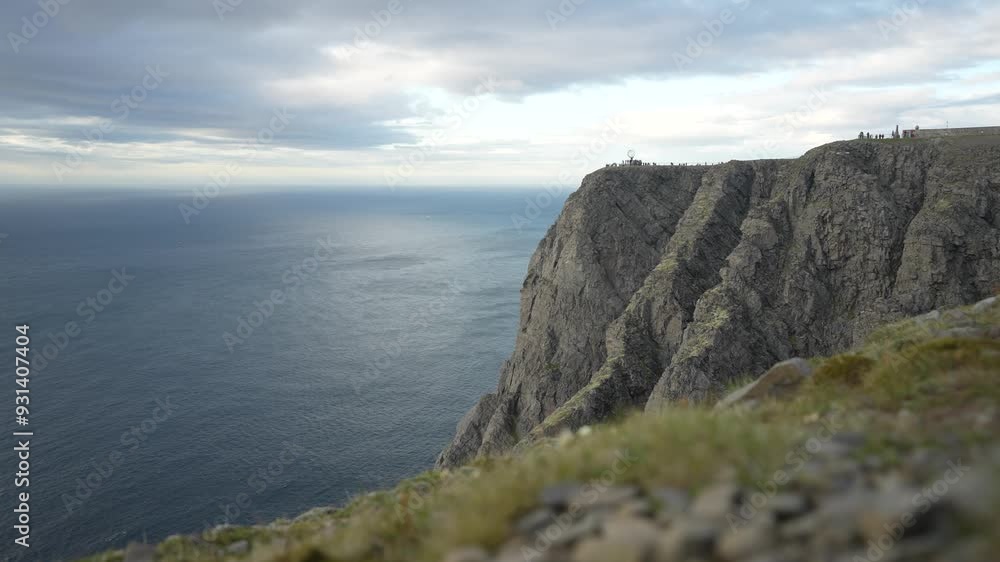 Time-lapse of people at north cape monument, in front of moving fog in the barent sea, in Nordkapp, Finnmark, Norway Time-lapse of people at north cape monument, in front of moving fog in the barent sea, in Nordkapp, Finnmark, Norway