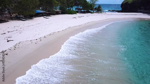 Aerial video of tropical beach blue ocean sea clear water white sand paradise in Flores Indonesia, flay forward over the coastline photo