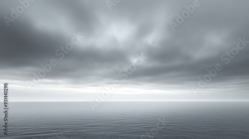 A serene, overcast sky with thick, soft clouds covering the horizon. The muted gray tones create a calm