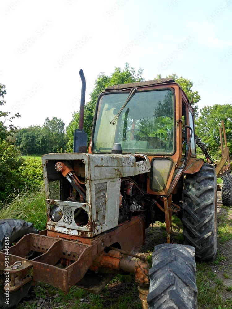 Hiking in the Argonne forest in France - View of a ruined tractor Hiking in the Argonne forest in France - View of a ruined tractor