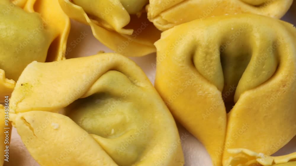 tortellini, rotation in circle. fresh pasta, Turning. Typical Italian dish. ravioli tortellini with parmesan cheese tortellini, rotation in circle. fresh pasta, Turning. Typical Italian dish. ravioli tortellini with parmesan cheese