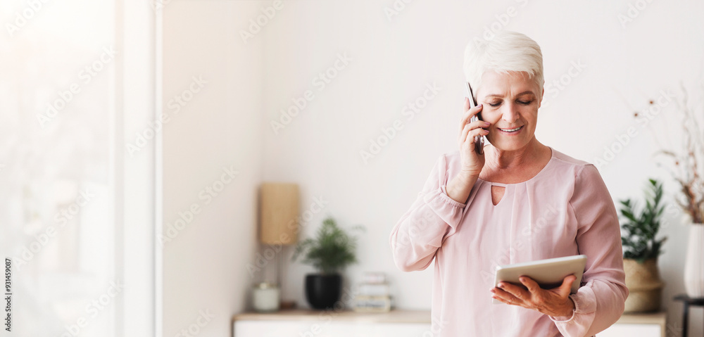 Busy senior woman consulting client on phone and reading contract on digital tablet at home, copy space Busy senior woman consulting client on phone and reading contract on digital tablet at home, copy space