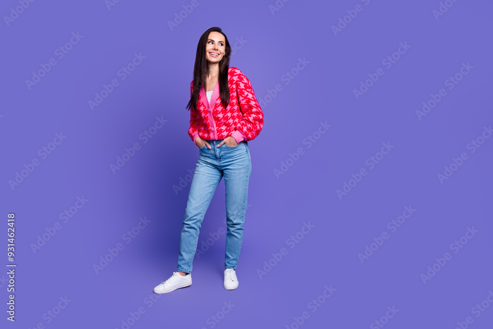 Full length photo of charming positive woman wear pink cardigan smiling looking empty space isolated purple color background Full length photo of charming positive woman wear pink cardigan smiling looking empty space isolated purple color background