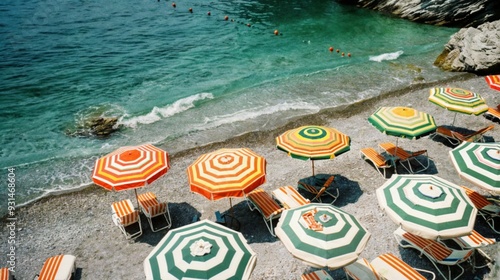 A lively scene at a beach, where numerous colorful umbrellas are set up along the shore, providing shade for the bathers. photo