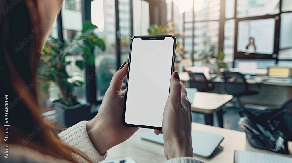 Woman Holding Smartphone with Blank Screen in Office Setting Woman Holding Smartphone with Blank Screen in Office Setting