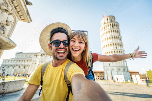 Obraz na plátně Happy tourist couple taking selfie picture in front of the famous leaning Tower