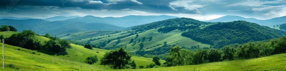 A beautiful green field with a mountain in the background. The sky is cloudy, but the sun is still shining through A beautiful green field with a mountain in the background. The sky is cloudy, but the sun is still shining through