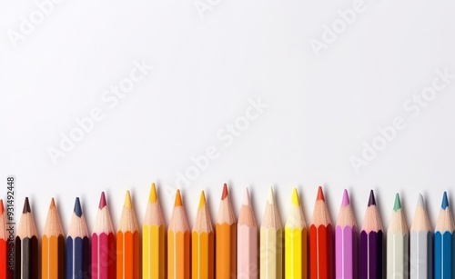 Set of colored pencils of different colors and a sharpener, on white background, copy space for text