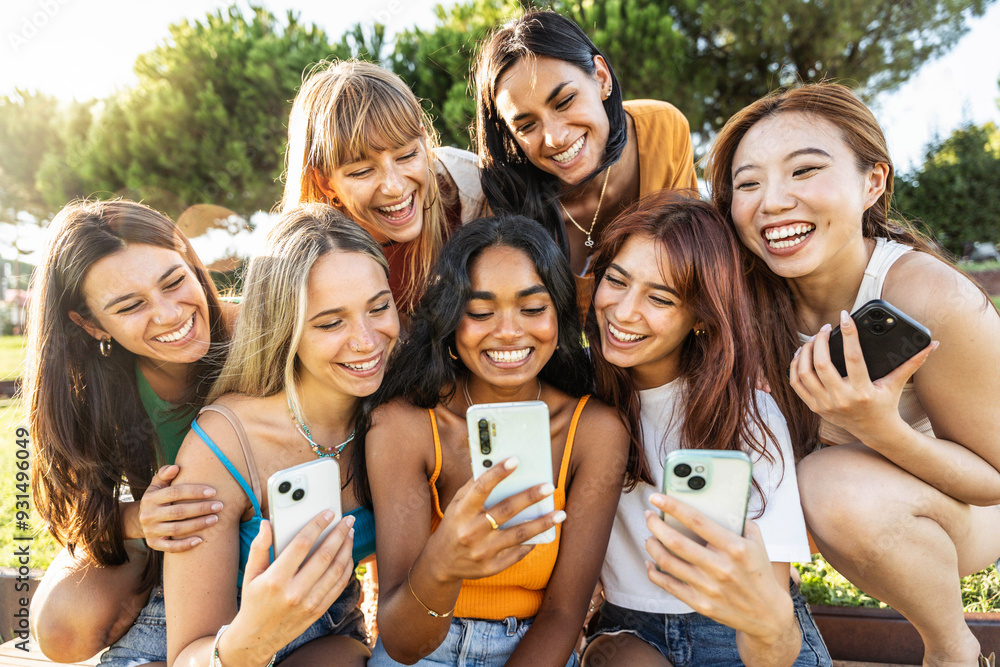 Happy group of young women using smart mobile phone device outside - Laughing friends watching funny social media reel with smartphone - Youth culture life style concept with teens holding mobile cell Happy group of young women using smart mobile phone device outside - Laughing friends watching funny social media reel with smartphone - Youth culture life style concept with teens holding mobile cell