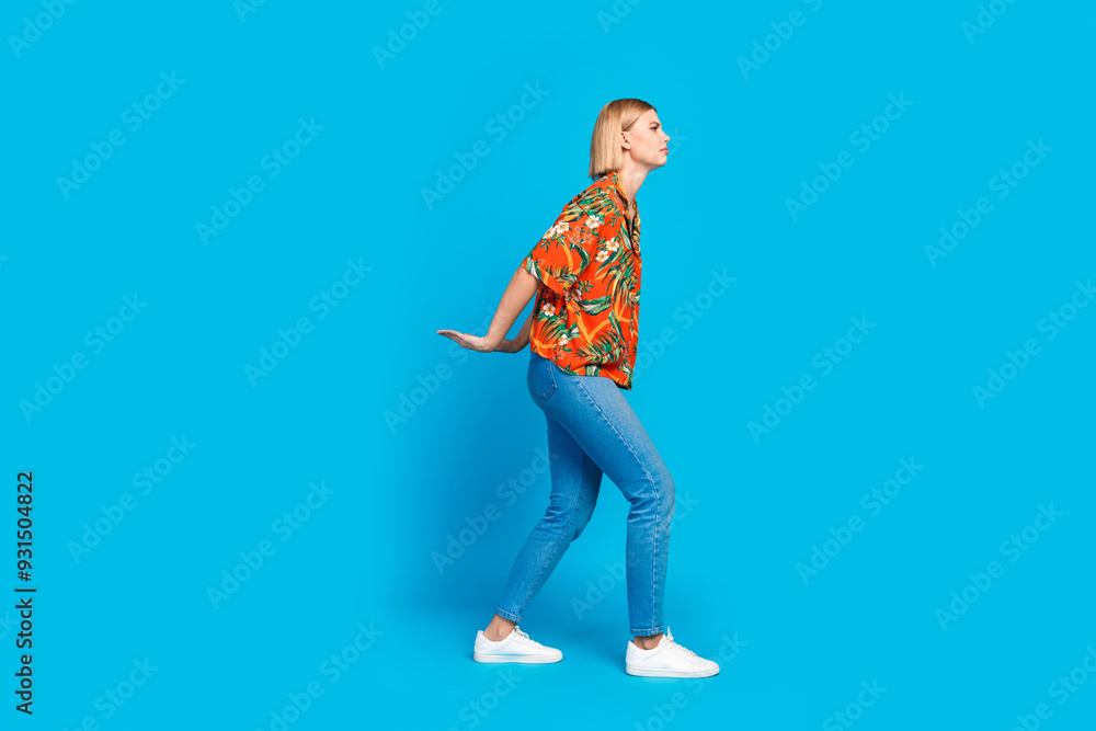 Photo of tired young sad girl wear stylish print clothes carry heavy empty space isolated on blue color background Photo of tired young sad girl wear stylish print clothes carry heavy empty space isolated on blue color background